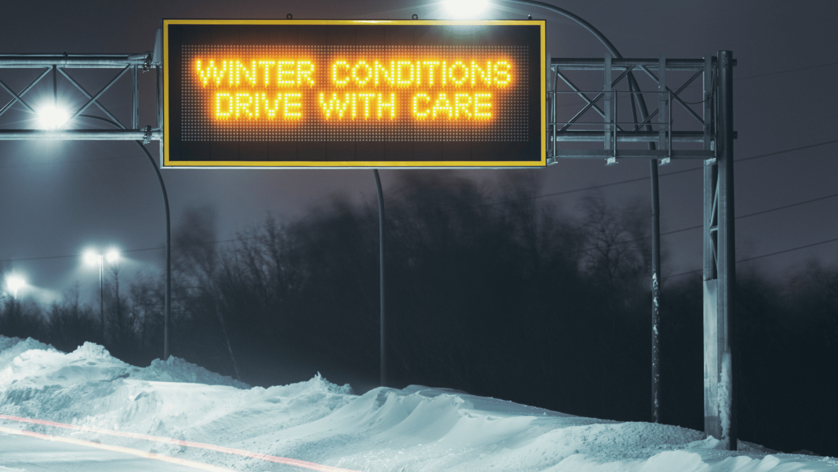 winter road conditions warning sign on roadway